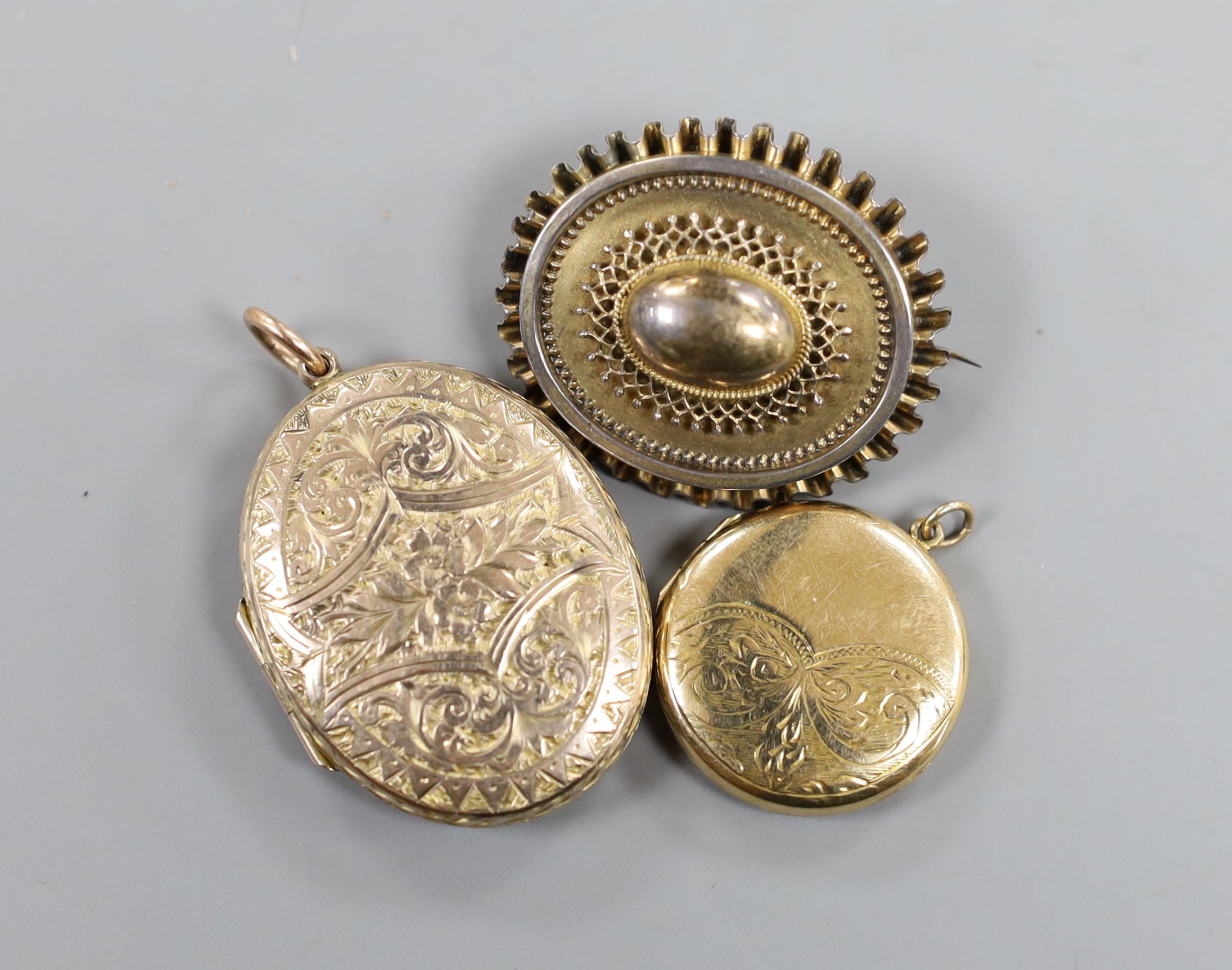 A Victorian yellow metal mourning brooch, with plaited hair beneath a glazed panel verso, 35mm and two engraved lockets.